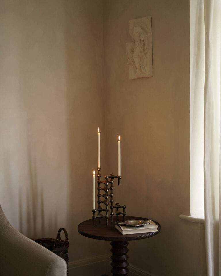 nagel-candle-holders-in-bronzed-brass and cream candles