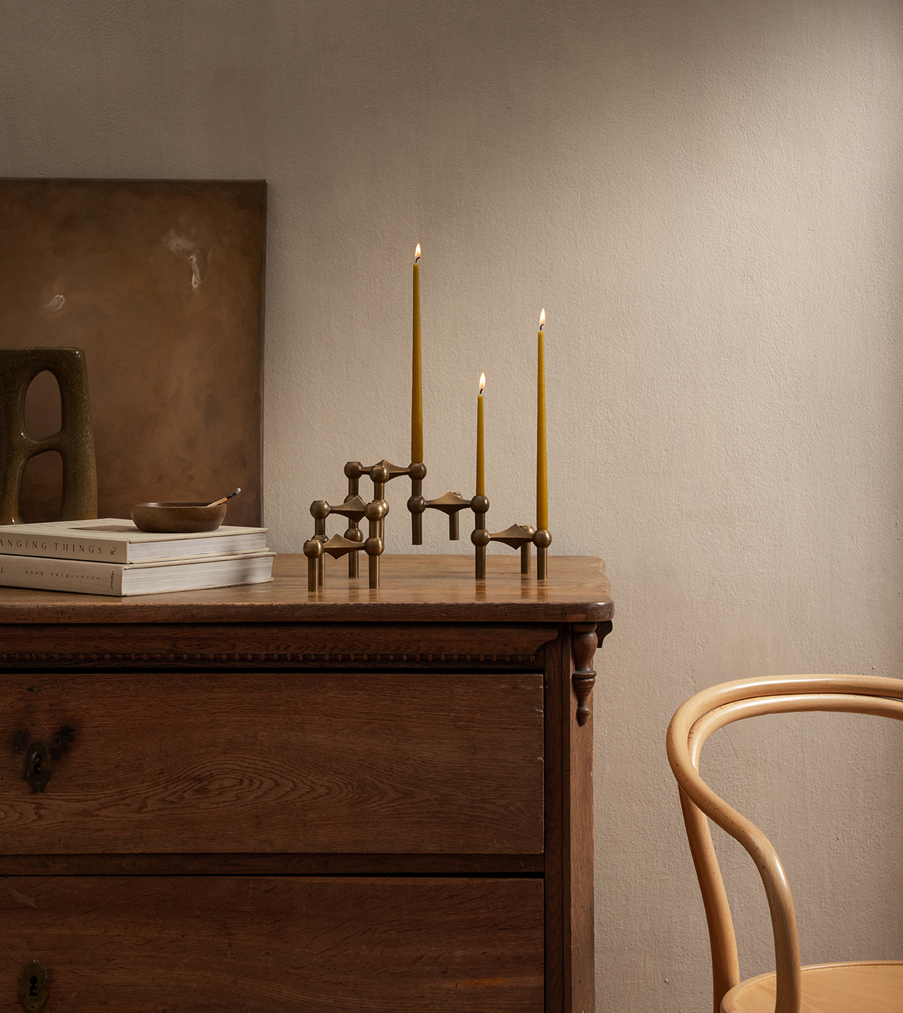 stoff nagel mustard taper candles and bronzed brass candle holders