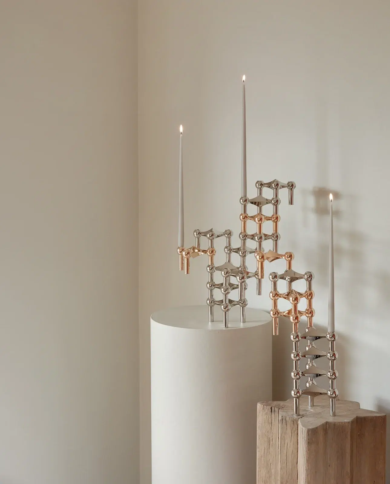 stoff nagel rose gold candle holders mixed with chrome candle holders into a sculptural formation