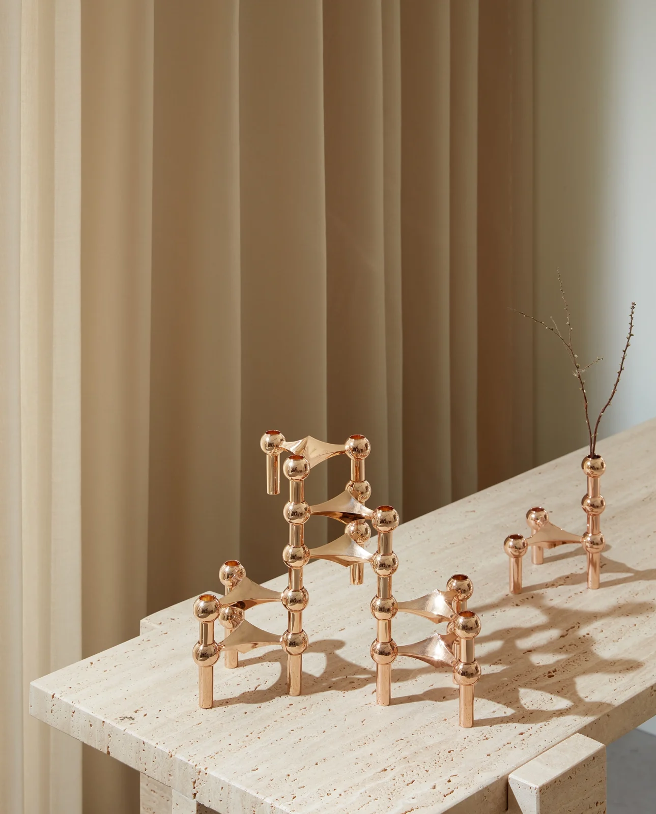 stoff nagel rose gold candle holders and vase in a sculptural formation