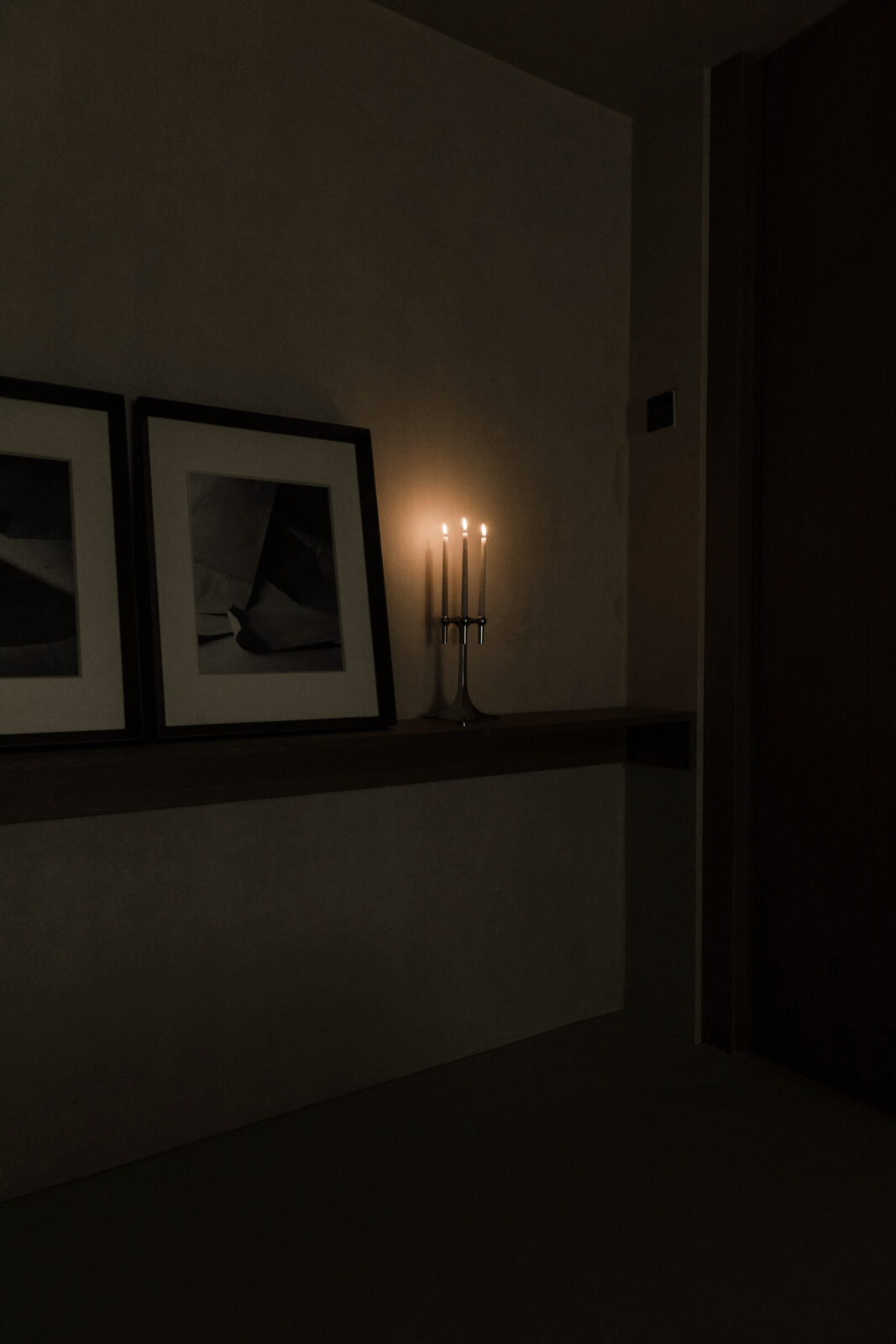 in the home of artistic duo Anton + Aiguabella decorating with a STOFF Nagel candelabra in chrome with lit taper candles.