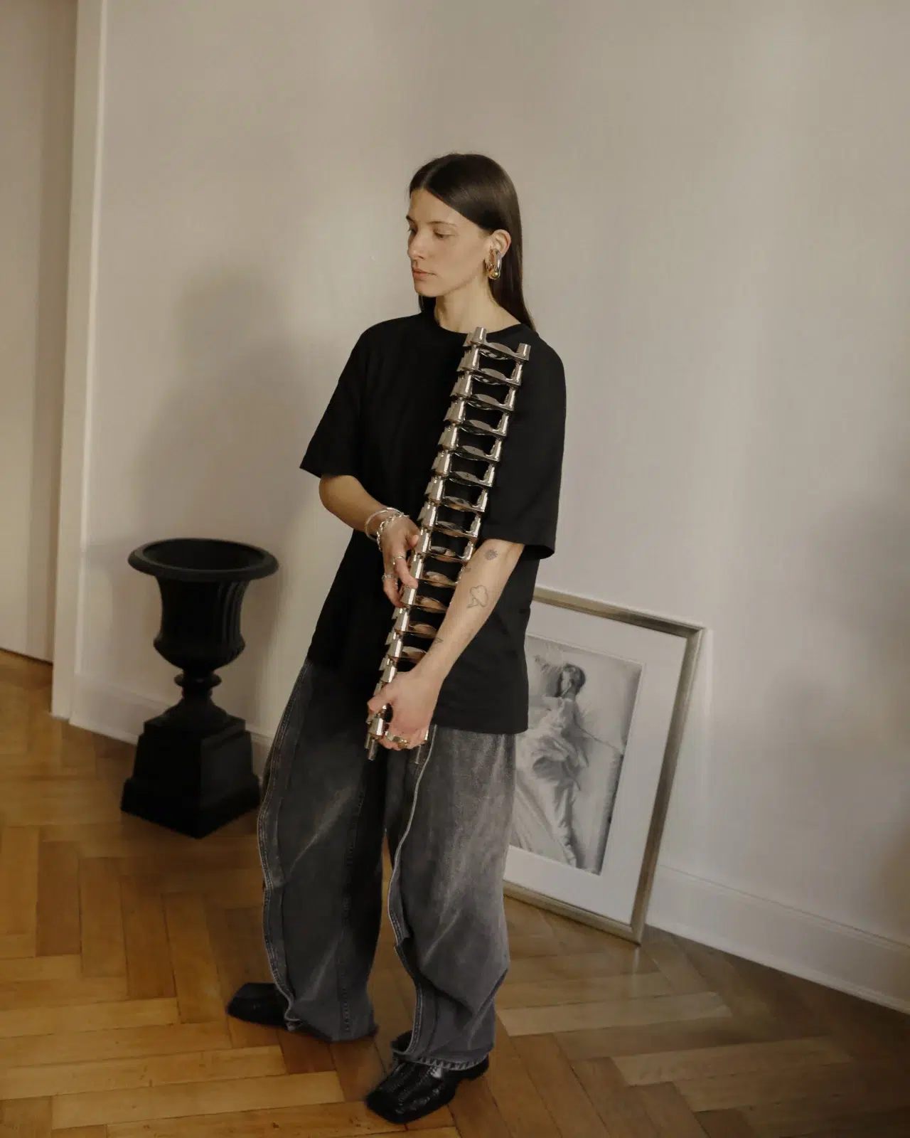 Linda Käckermann for STOFF Nagel holding a stack of BMF candle holders in chrome.