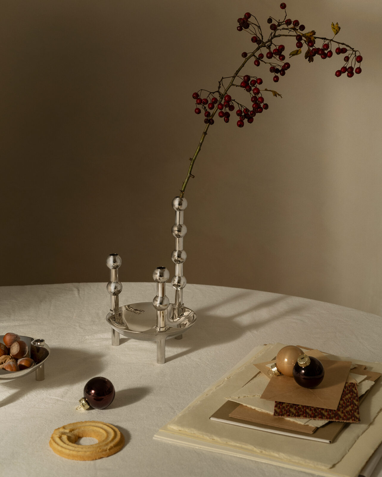 A Christmas table setting with the stoff nagel bowl and vases.