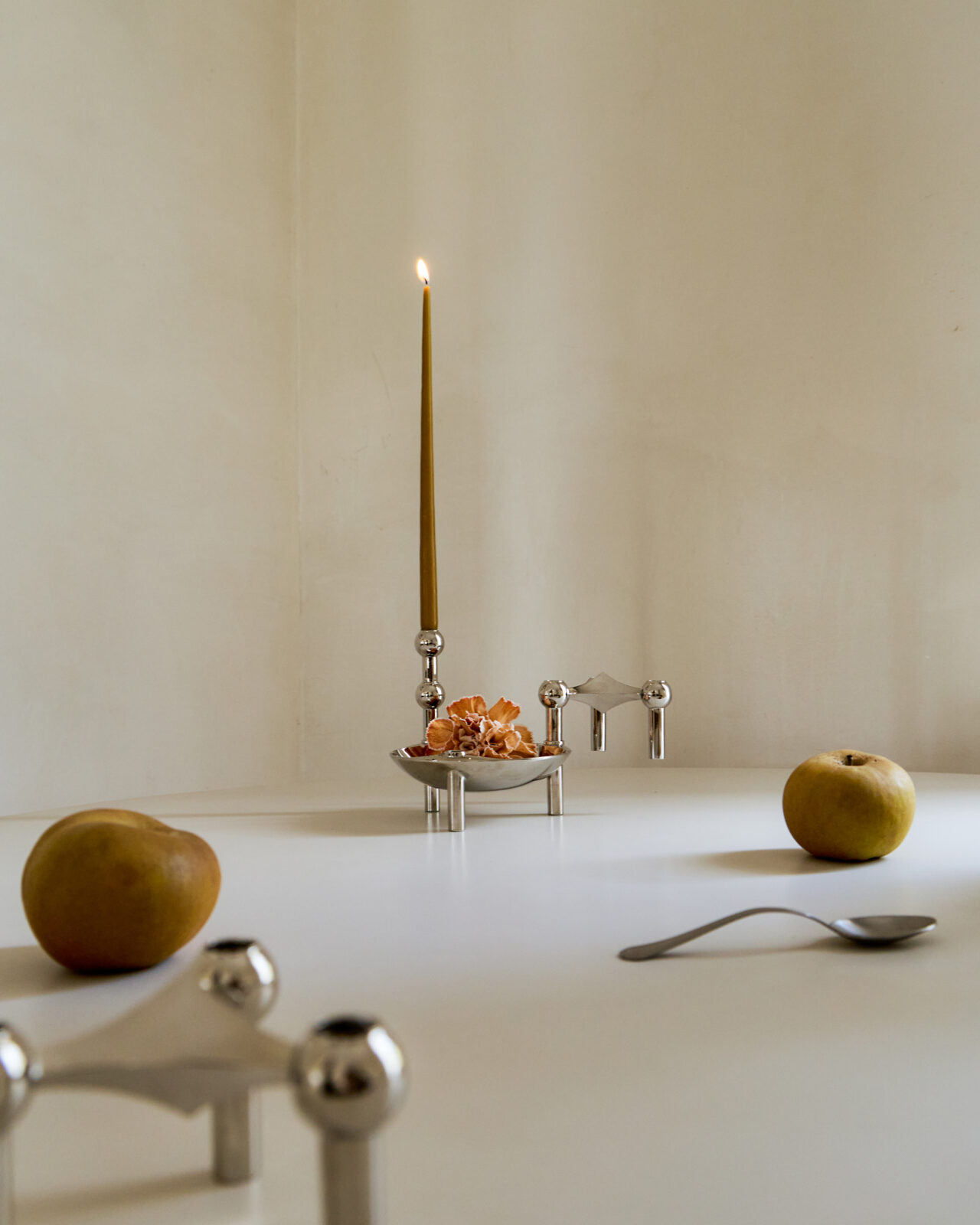 stoff nagel x claudia longarte. the nagel candle holders, bowl and vase in a sculptural formation on a table