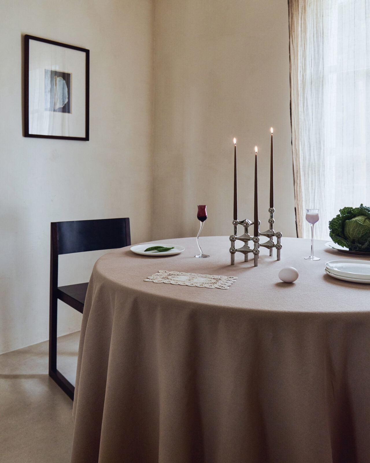 stoff nagel x claudia longarte. nagel candle holders in chrome arranged on a table with three lit candles