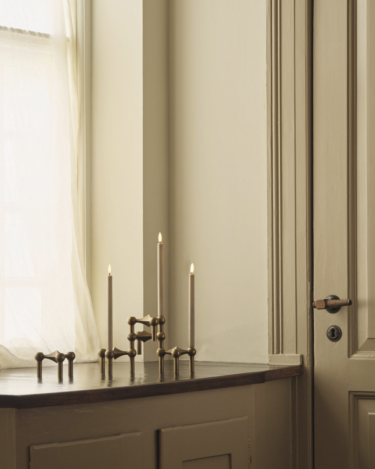 nagel candle holders in bronzed brass holding the stoff nagel led candles