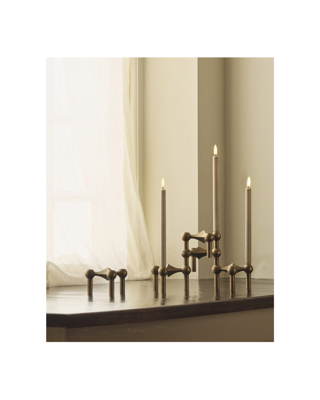 nagel candle holders in bronzed brass holding the stoff nagel led candles