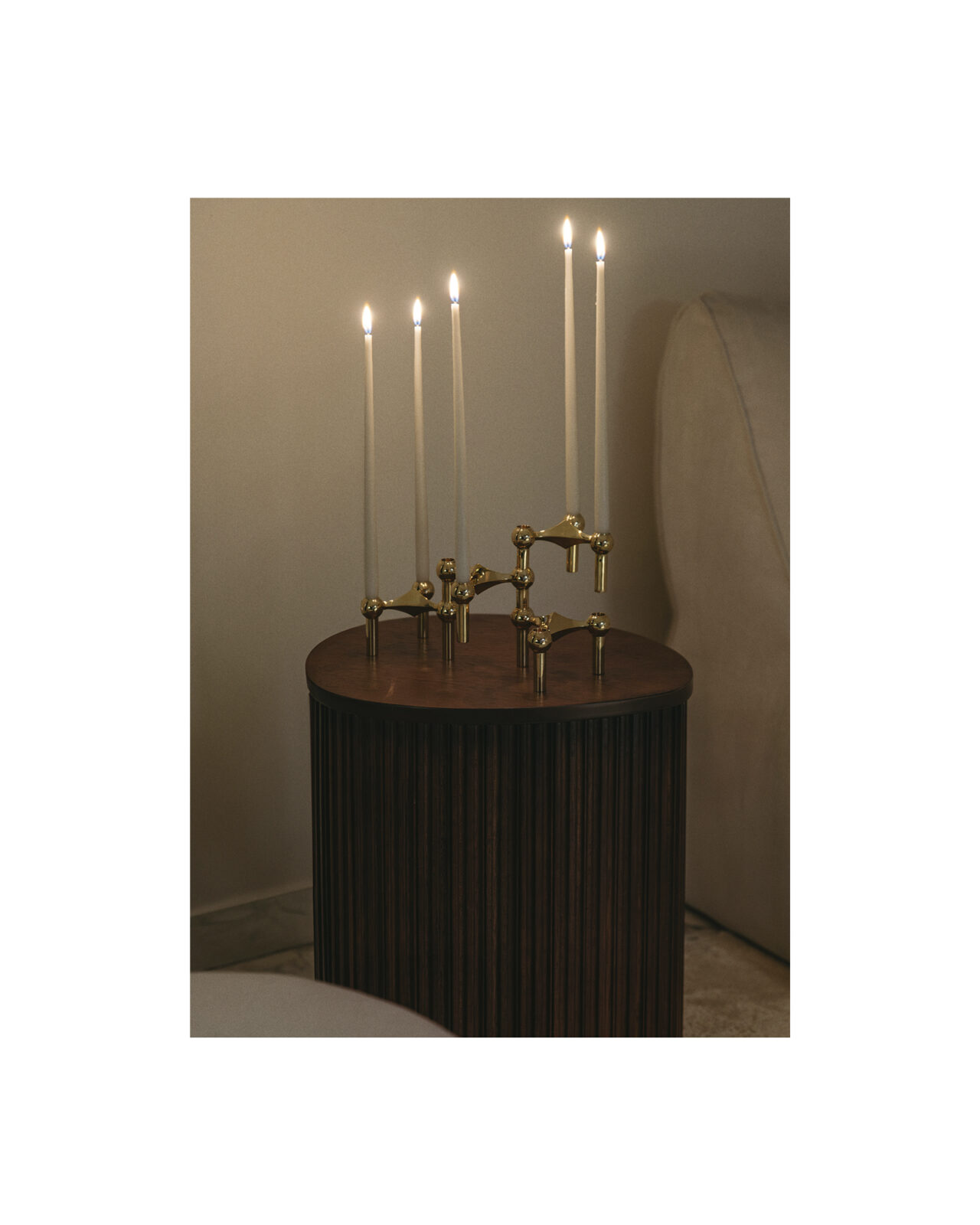 stoff nagel candle holders in solid brass with lit taper candles