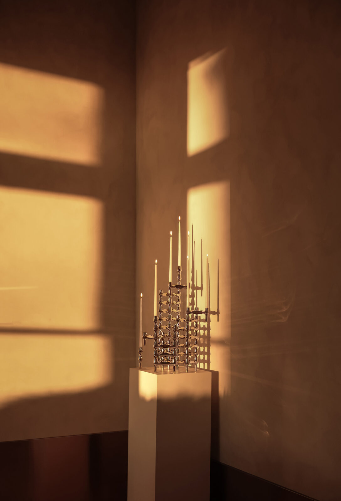 stoff nagel: a candle holder sculpture made of BMF candle holders in chrome